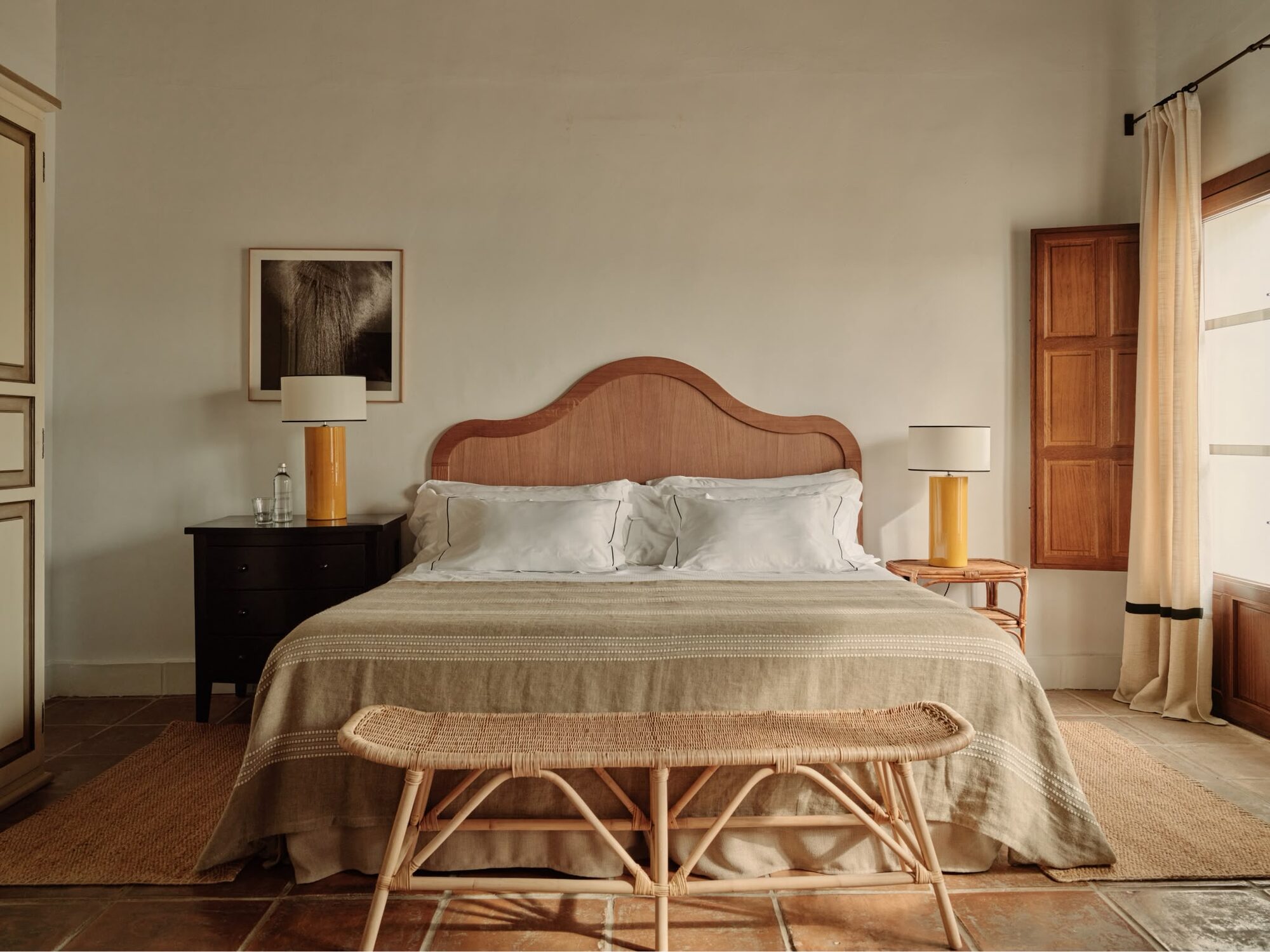 An elegant, softly lit bedroom with traditional Andalusian tiling